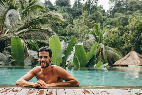 Handsome young man in swimming pool