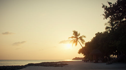 Beautiful sunset over a tranquil island resort beach, perfect for family vacations