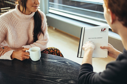Man showing final college presentation to friend