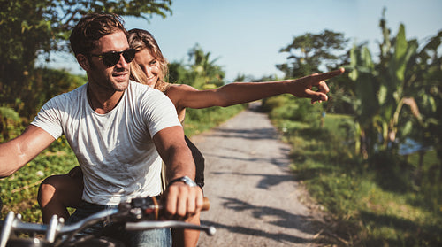 Beautiful young couple riding motorbike