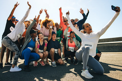 Group of runners taking a cheerful selfie after community run