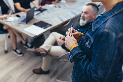 Businesswoman giving presentation to colleagues