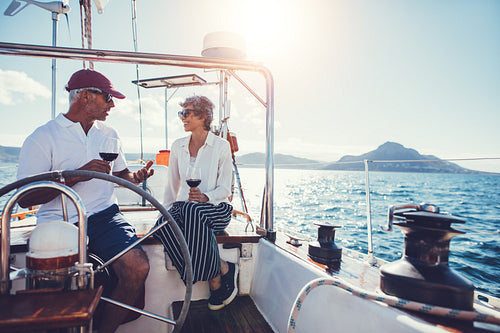 Mature couple having wine on boat trip