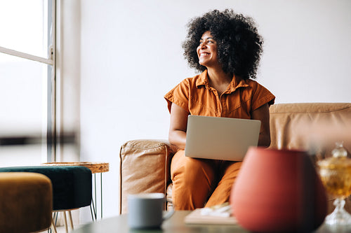Pensive young businesswoman looking away with a smile