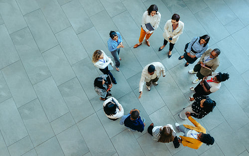 A group of corporate professionals engage in an orientation meeting in a casual setting