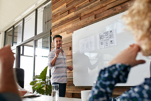 Young man discussing new mobile application during a creative presentation