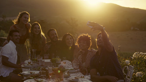 Group selfie at dinner party