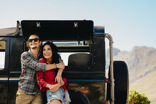 Couple by their car admiring a view