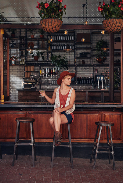 Stylish young woman relaxing at a cafe with a drink