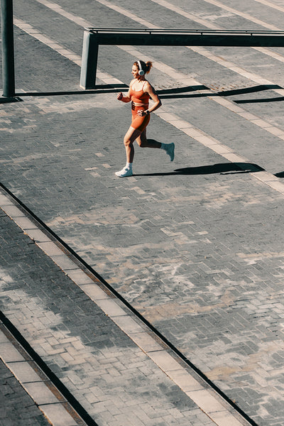 Wellbeing and exercise: Athletic woman running up stairs for cardio training