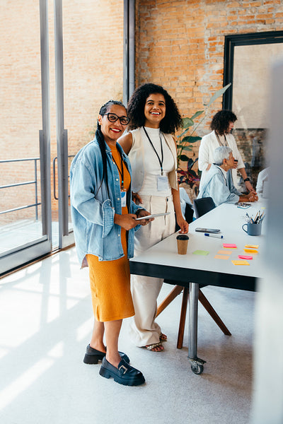 Smiling professionals in a modern office during a creative brainstorming session