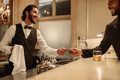 Bartender receiving credit card from a customer