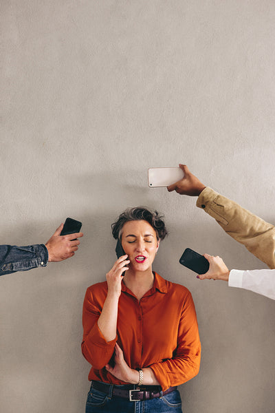 Businesswoman answering a phone call in a demanding work environment