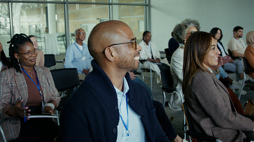 Audience applauding enthusiastically at a professional seminar event