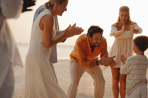 Family creating joyful memories while dancing on vacation