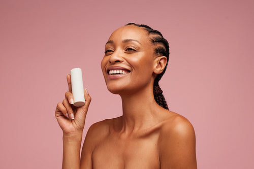 Good looking woman holding beauty product