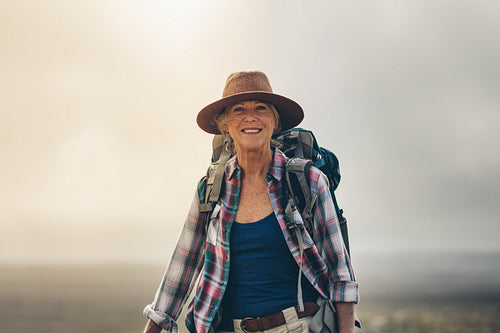 Portrait of a cheerful senior woman in hat