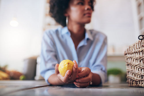 Woman at a juice bar counter with lemon