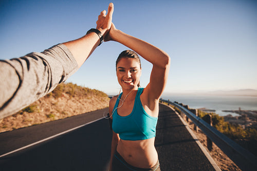 Man and woman high fiving after running training