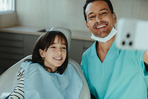 Dentist and child take a selfie during a positive clinic visit