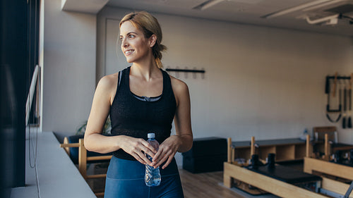 Woman standing in a pilates training gym