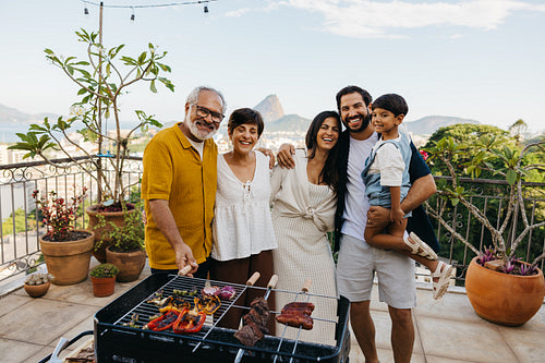 Family enjoying Brazilian churrasco on a terrace with a scenic backdrop