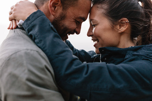 Beautiful young couple smiling together outdoors