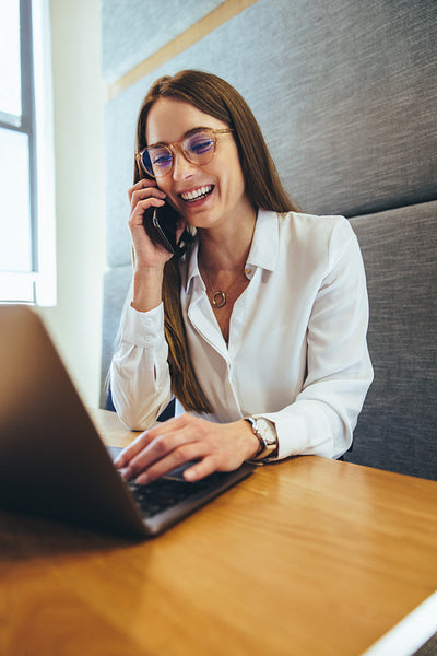 Happy entrepreneur smiling during a phone call
