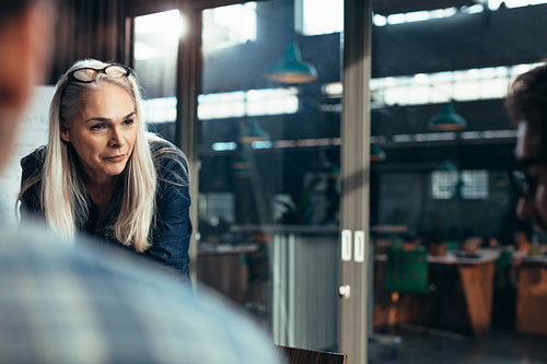 Business woman talking with colleagues in meeting