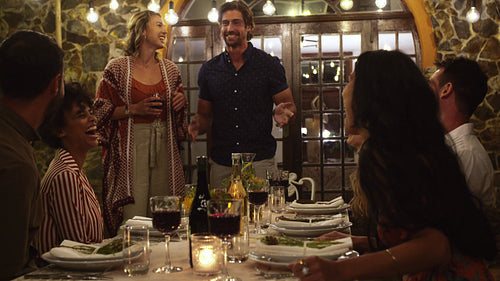 Couple toasting drinks with guest