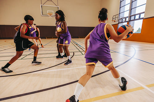 Chasing greatness: Female basketball players in action during a competitive game"