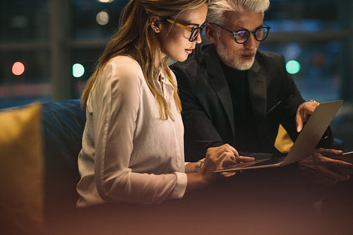 Business professionals working late in office