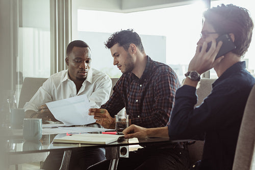 Businessmen discussing ideas at a table