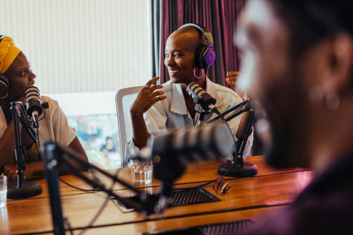 Engaging podcast recording session with smiling hosts in studio