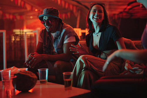 Happy friends chilling together at a night festival party