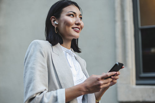 Woman using a smartphone while walking in the city