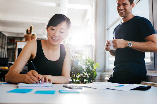 Two business people working at desk together