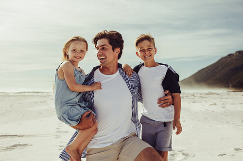 Man with his children on the beach