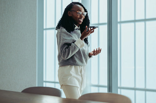 Black entrepreneur participating in a conference call with a smartphone