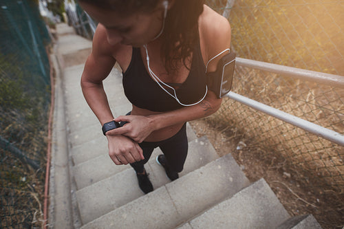 Sports woman checking the time on a smart watch