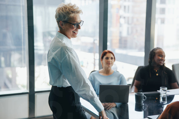 Mature business woman meeting with her colleagues to discuss a business proposal