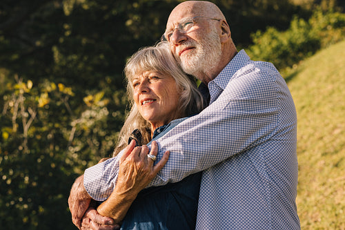Romantic senior couple embracing each other in a park