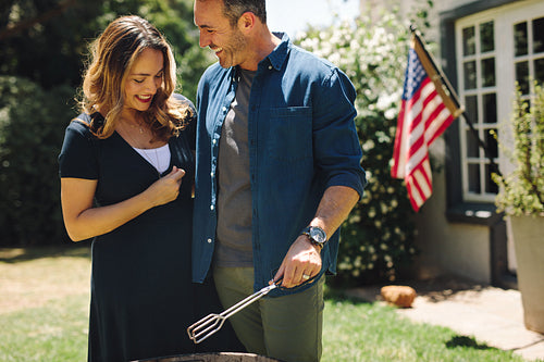 Smiling couple standing together in backyard
