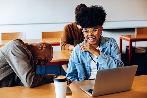 Laughter between deadlines: Coworkers sharing a break during office work