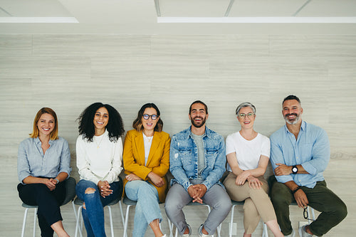 Successful job applicants sitting in a row