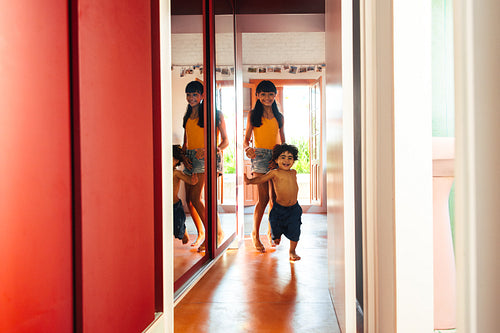 Young siblings enjoy a playful moment in a vibrant home environment