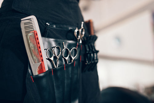 Hairdressing accessories arranged in compartments of a salon holster