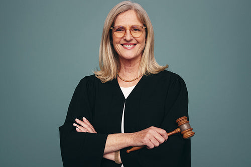 Successful female judge smiling at the camera in a studio