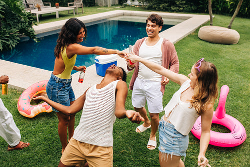 Playing limbo by the pool with friends