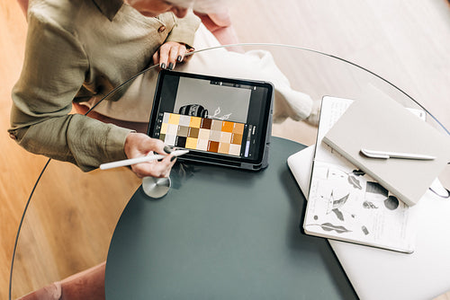 Mature graphic designer drawing on a digital tablet